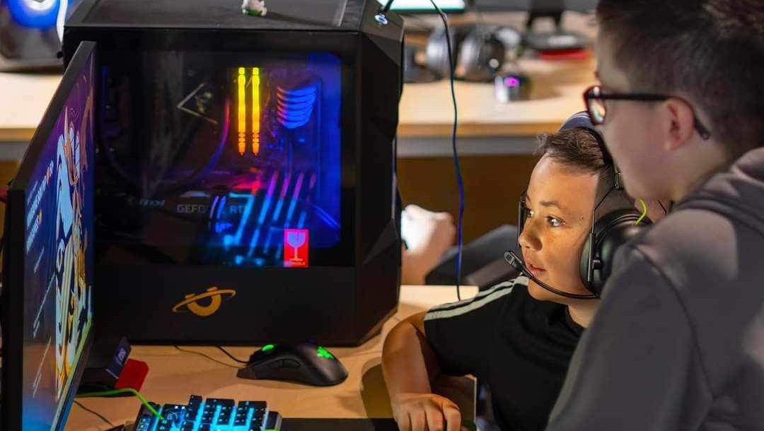 Child playing on a computer with neon lights
